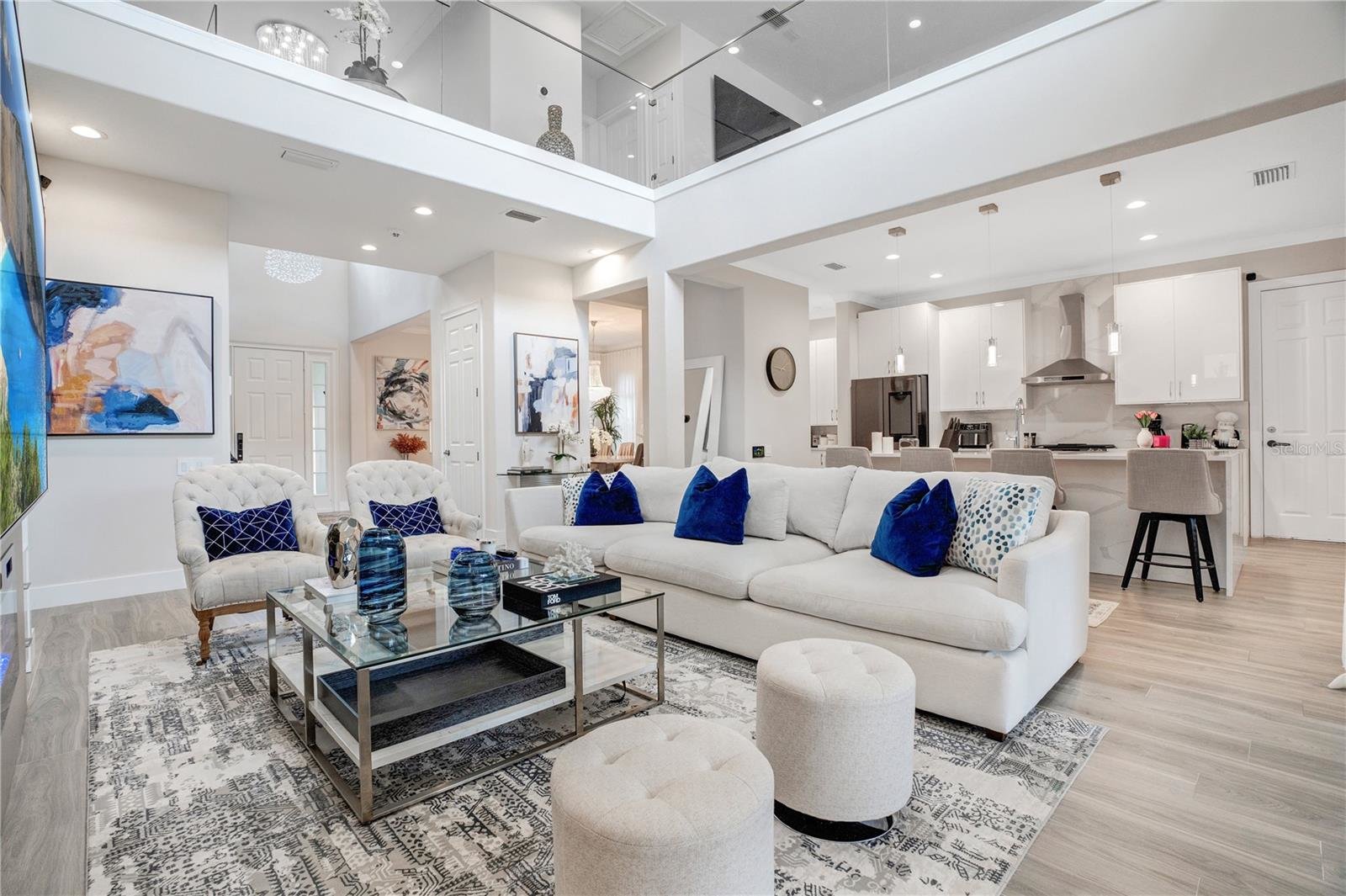 contemporary living room with light furniture and blue accents